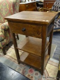 END TABLE; SINGLE DRAWER AND 2 LOWER SHELF END TABLE WITH METAL DRAWER PULL. MEASURES 20 IN X 16 IN