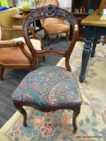 BALLOON BACK CHAIR; 1 OF A PAIR OF MAHOGANY BALLOON BACK CHAIRS WITH ROSE CARVED CRESTS AND PAISLEY