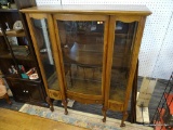 CHINA CABINET; OAK SINGLE DOOR CHINA CABINET WITH 1 LOWER DRAWER. HAS QUEEN ANNE LEGS AND SITS ON
