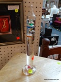 GLASS GALILEO THERMOMETER; MULTICOLORED TEMPERATURE BUBBLES WITH OVAL SHAPED TAGS BELOW WHICH