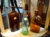 VINTAGE GLASS BOTTLES SHELF LOT; INCLUDES 4 TOTAL PIECES. 3 ARE BROWN BOTTLES (1 HAS MARKINGS FROM A