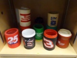 SHELF LOT OF BEER COOZIES; INCLUDES A JOHN DEERE, A DALE EARNHARDT SR, A DAYTONA 500, AND MORE!