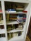 (GAME) SHELF LOT OF BOOKS; RIGHT OF BOOKCASE, 4 SHELVES OF BOOKS AND A FEW VHS TAPES- BOOKS INCLUDE-