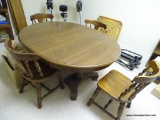 (GAME) TABLE AND CHAIRS; ROUND OAK TABLE AND 4 CHAIRS- HAS 1 LEAF, TABLE WITH LEAF IN MEASURES- 56