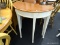 HALF-MOON SHAPED HALL TABLE WITH WOOD GRAIN TOP AND CREAM SPECKLED BASE; OFF WHITE IN COLOR (FACTORY