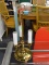BRASS TABLE LAMP; HAS 3 LIGHTS WITH A HOOP FINIAL. MEASURES 18 IN TALL