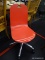 RED AND CHROME ROLLING OFFICE CHAIR; MODERN ROLLING CHAIR WITH BENT SEAT AND BACK. MEASURES 17 IN X