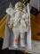PORCELAIN DOLL; HERITAGE SIGNATURE COLLECTION COLLECTIBLE PORCELAIN DOLL IN AN ICE SKATER OUTFIT