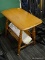 MAPLE END TABLE WITH LOWER MAGAZINE RACK; HAS TURNED LEGS AND MEASURES 16 IN X 25 IN X 24 IN
