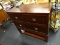 DARK WOOD GRAIN 2 DRAWER DRESSER; HAS 2 DRAWERS WITH PEWTER PULLS AND A LOWER STORAGE SHELF.