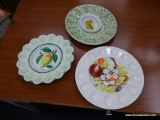 EGG PLAT LOT; THIS LOT INCLUDES 3 ASSORTED EGG PLATES. ONE IS WHITE WITH FRUIT AND FLOWERS ON IT