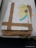 QUILT; IS WHITE, YELLOW AND BROWN IN COLOR WITH A SUNFLOWER PATTERN. IS IN EXCELLENT CONDITION!