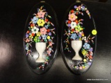 TRAMP ART WALL PLAQUES; PAIR OF NAIL MADE FLORAL WALL DECORATIONS ON BLACK WOODEN BACKGROUND.