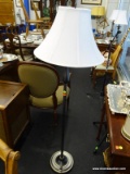 FLOOR LAMP; WHITE BELL SHAPED LAMPSHADE ATOP A POST WHICH IS DARK BRUSHED GREY METALLIC COLOR, WITH