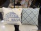 (R3) PAIR OF ACCENT PILLOWS; 1 HAS A DIAMOND PATTERN IN GREEN AND BLUE AND 1 IS ADVERTISING LARRO