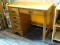 (R3) SINGLE PEDESTAL DESK; MADE BY CRAWFORD FURNITURE. HAS 1 CENTER DRAWER AND 3 SIDE DRAWERS. TOP