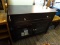 (R4) ENTERTAINMENT STAND; BLACK WOODEN FINISH ENTERTAINMENT STAND WITH 1 DRAWER OVER 2 GLASS DOORS.