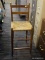 (R4) BAR STOOL; OAK AND RUSH BOTTOM BAR STOOL WITH LOWER FOOTRESTS. IS IN GOOD USED CONDITION AND