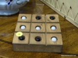 (R1) WOOD AND MARBLES TIC-TAC-TOE GAME; SQUARE WOODEN CASE WITH ROTATING PANEL TO HOLD 10 BLACK OR