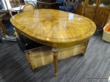 (R2) OVAL WOODEN DINING TABLE WITH INLAY PATTERNED TOP SURFACE; HAS OCTAGONAL LEGS AND IS IN VERY