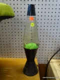 (R3) LAVA LAMP; IS GREEN IN COLOR WITH BLACK BASE AND TOP. IS IN VERY GOOD CONDITION! MEASURES 17 IN