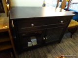 (R4) ENTERTAINMENT STAND; BLACK WOODEN FINISH ENTERTAINMENT STAND WITH 1 DRAWER OVER 2 GLASS DOORS.