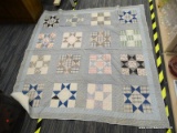(R1) VINTAGE QUILT; MEASURES ABOUT 68 IN X 66 IN. STAR PATTERNED BLOCKS WITH LIGHT AND DARK BLUE