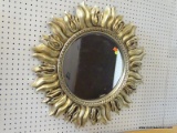 (R1) SUN SHAPED WALL MIRROR; BEVELED MIRROR GLASS FRAMED IN GOLD COLORED MOLDED SUN DESIGN BORDER.