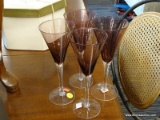 (R1) AMETHYST GLASS STEMWARE SET; TOTAL OF 4 PIECES OF TALL FLARED TOP FLUTES, EACH MEASURES 8 3/4