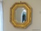 (DR) GOLD COLORED OCTAGONAL WALL MIRROR; BEVELED GLASS SURROUNDED BY A MOLDED SHADOW BOX-STYLE