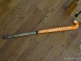 (UP) GRYPHON 25MM FIELD HOCKEY STICK; ORANGE AND WHITE IN COLOR WITH TAPED GRIPPING HANDLE. MEASURES