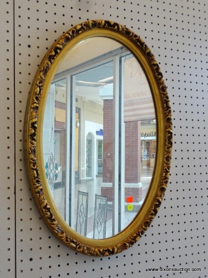 OVAL MIRROR IN GOLD TONED MOLDED FRAME; MEASURES 26 IN X 18 IN.