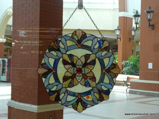 (WIN) HANGING STAINED GLASS-LIKE PIECE; LARGE, ROUND, MULTICOLORED WITH SHADES OF PALE YELLOW, BLUE,
