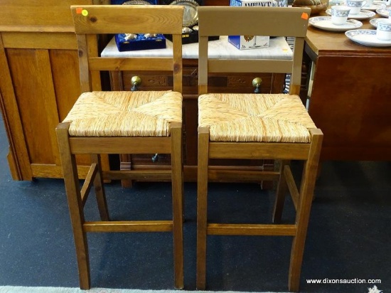 RUSH SEAT BAR STOOLS; TOTAL OF 2. BOTH HAVE SLATTED BACKS AND SQUARE LEGS WITH FOOT RAILS ALL