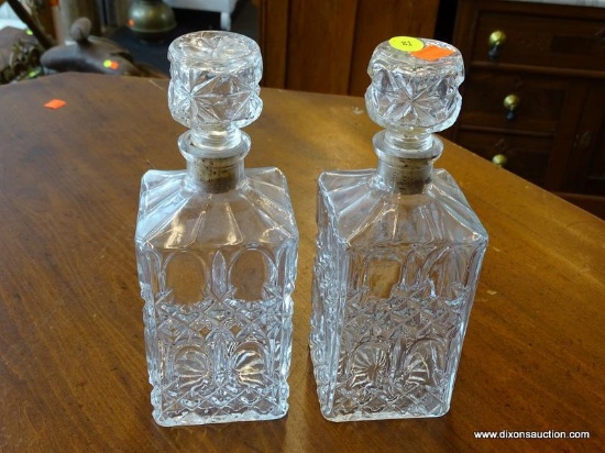 VINTAGE PRESSED GLASS DECANTERS; TOTAL OF 2. EACH HAVE ORIGINAL STOPPERS AND MEASURE 4 IN X 4 IN X