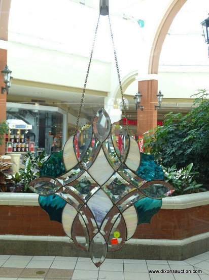 (WIN) HANGING STAINED GLASS-LIKE PIECE; ROUND/DIAMOND SHAPED, IN SHADES OF TEAL AND OPALESCENT