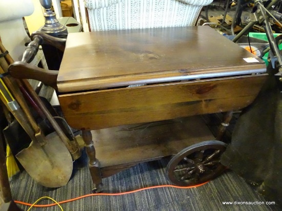TEA CART; PINE TEA CART WITH DROP-SIDES AND A LOWER SHELF. HAS A TURNED HANDLE AND SPINDLE WHEEL
