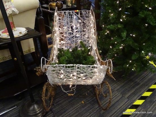 PRE-LIT SLEIGH; WHITE WICKER AND BROWN VINE WOVEN SLEIGH WITH WHITE CHRISTMAS LIGHTS. HAS A RED BOW