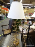 TABLE LAMP; GOLD TONED TABLE LAMP IN THE FORM OF A LEAF PLANT WITH A WHITE BELL SHAPED SHADE AND