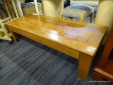 COFFEE TABLE; MISSION STYLE OAK COFFEE TABLE WITH 4 IN BANDED TOP. MEASURES 55 IN X 22 IN X 15 IN