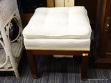 BUTTON TUFTED STOOL; SQUARE, CREAM COLORED BUTTON TUFTED PILLOW TOP STOOL/OTTOMAN SITTING ON A