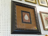 FRAMED LEAF PRINT; CREAM COLORED LEAF ON A BROWN BACKGROUND WITH A BLACK AND BROWN SHADOW BOX MAT.