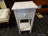 WOODEN SIDE TABLE; WHITE TABLE WITH SQUARE TOP, SINGLE DRAWER, AND LOWER SHELF. SITS ON 4 BLOCK