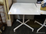 METAL TILT TOP TABLE; ONE OF A PAIR OF WHITE METAL TABLES. SQUARE TOP WITH HANDLE THAT WILL FOLD THE