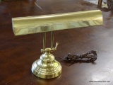 BRASS DESK LAMP; HAS A ROUND BASE WITH AN ADJUSTABLE ARM. MEASURES 14 IN X 15 IN