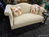 SINGLE CUSHION LOVE SEAT; SINGLE CUSHION CAMELBACK CREAM COLORED LOVE SEAT WITH MAHOGANY LEGS.