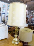 BRASS TABLE LAMP; PALE YELLOW DRUM SHAPED SHADE WITH WHITE ROSE PRINT SITTING ATOP A BRASS