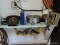 (SHOP 2) SHELF LOT; FIRST AID KITS, VINTAGE ROTARY PHONE, TIRE PRESSURE GAUGES, LICENSE PLATE