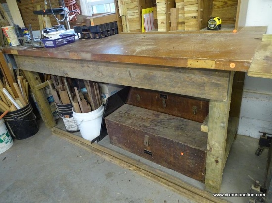 (WSHOP) WORKBENCH; SITS UPON 4 TREATED WOOD LEGS WITH THE TOP BEING MADE FROM AN OLD DOOR. IS IN