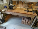 (WSHOP) WORKBENCH; SITS UPON 4 TREATED WOOD LEGS WITH THE TOP BEING MADE FROM AN OLD DOOR. IS IN